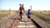 A mother and her children, pictured in 2015, walk across the border from Serbia to Hungary. 