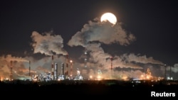 A full moon rises over Gazprom Neft's oil refinery in Omsk (file photo)