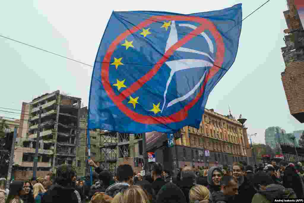 An anti-NATO and EU flag seen during the November 11 demonstration.Protesters are demanding the ruins remain untouched, while Vucic, who is now Serbia's president, has said the $500 million development will contribute to Belgrade becoming "the center of this part of the world."