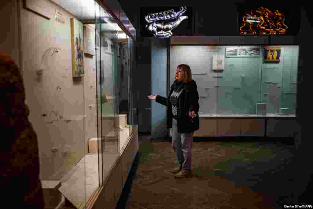 Olga Honcharova, who was director of the Kherson Regional Museum at the time, views empty displays at the museum in December 2022, shortly after Ukrainian forces recaptured the city following eight months of Russian occupation.The previous director of the museum reportedly fled Ukraine with retreating Russian forces and is accused of abetting the mass looting.